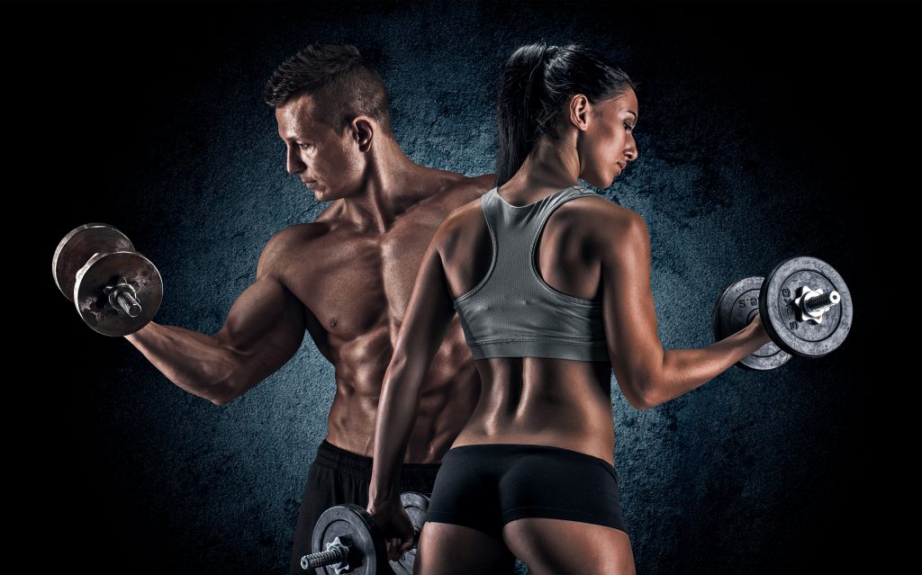 man and woman lifting weights