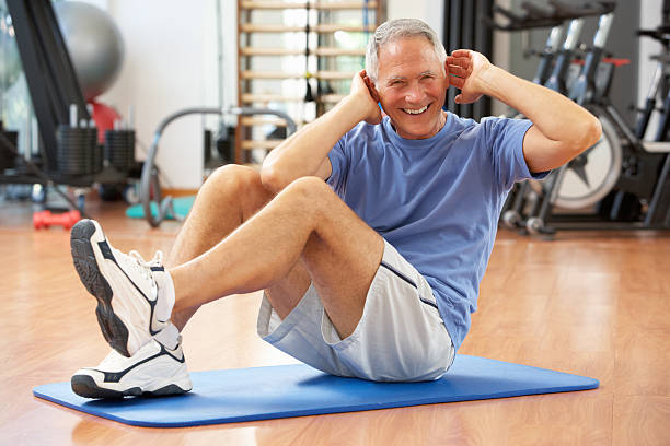 elderly man doing sit ups at home