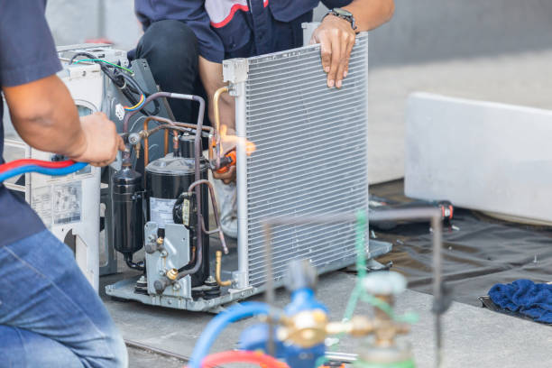 Technician repairing aircon compressor