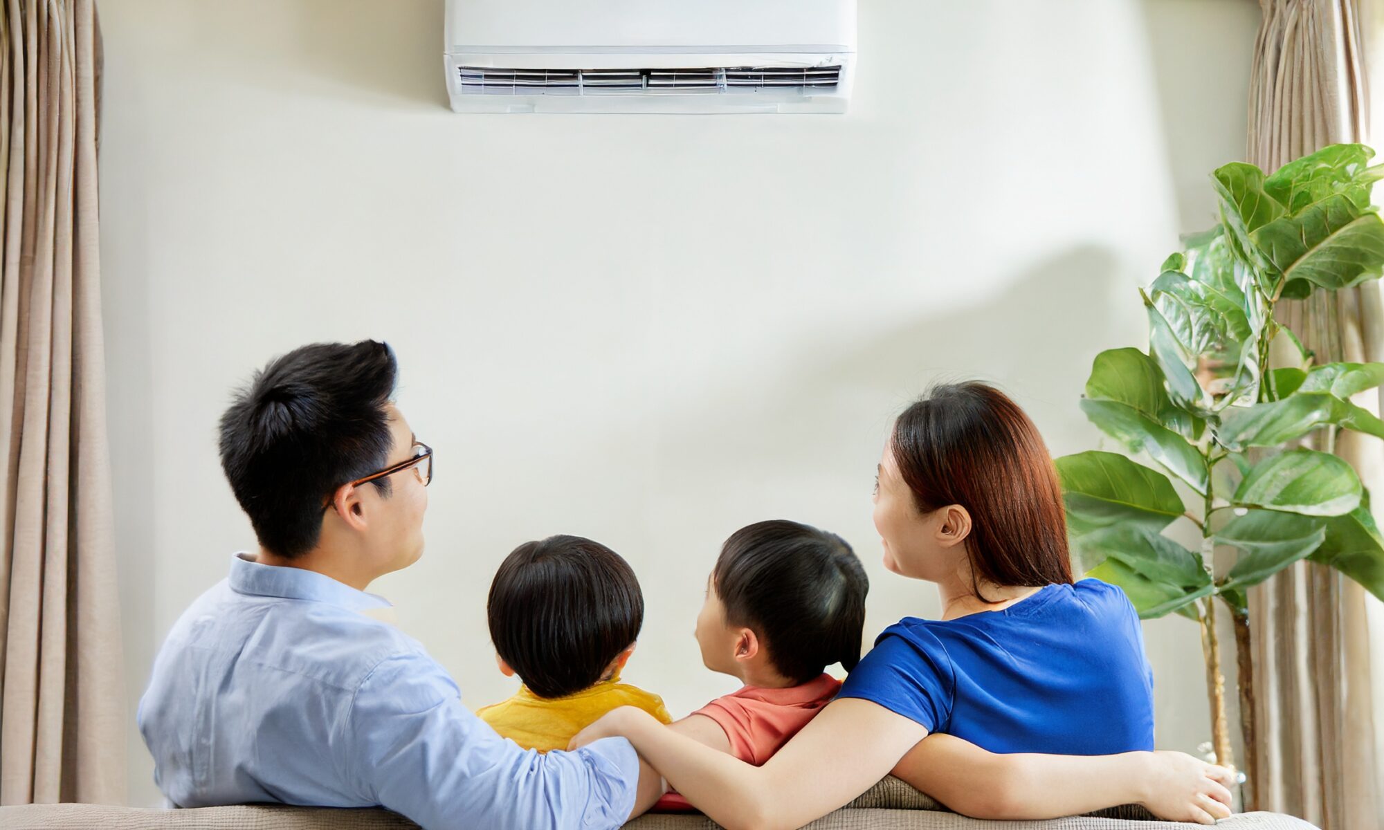 family enjoying cool air from aircon