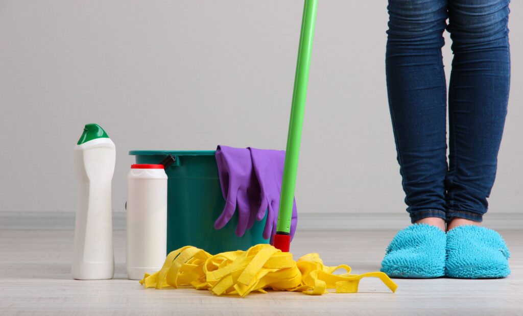 Image of a person standing next to cleaning equipments
