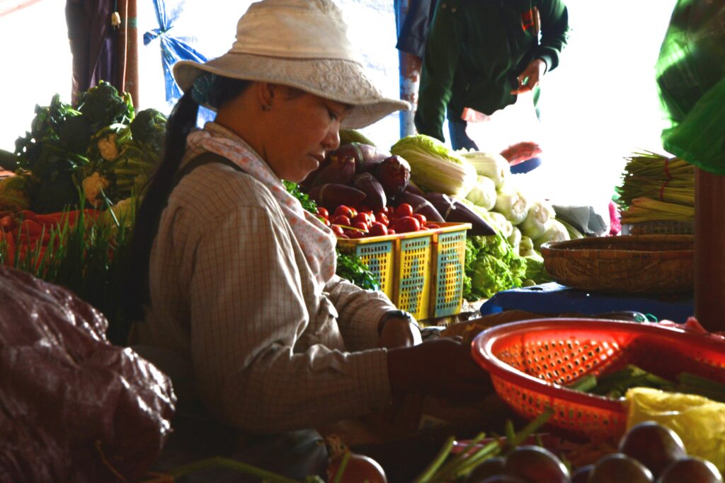 image of a vegetable seller at a wet market 