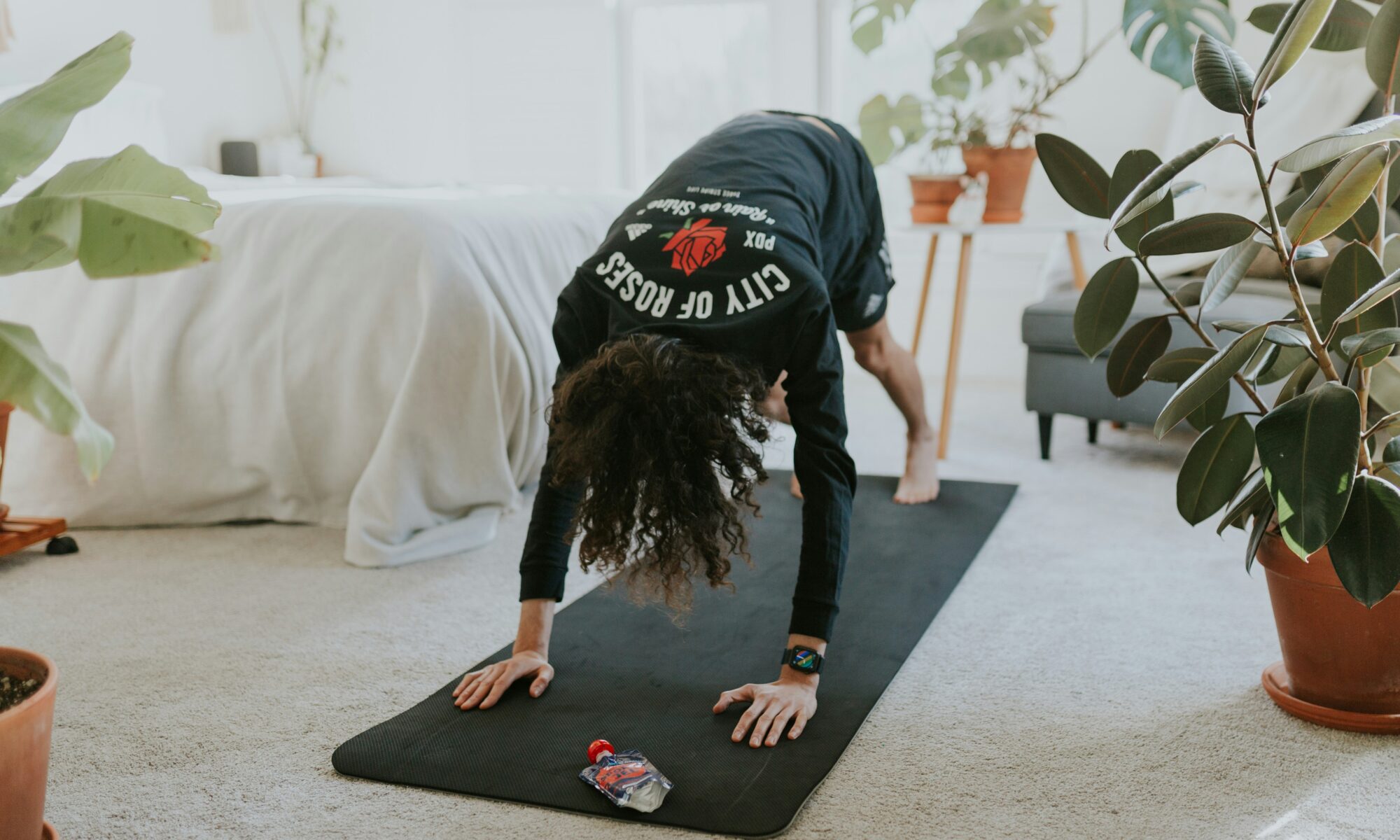 woman doing stretches atop a yoga mat