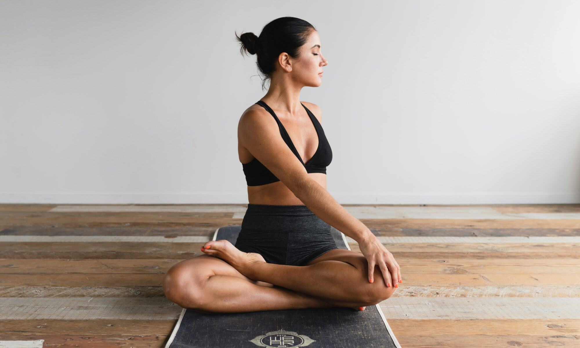 woman doing warm ups on a yoga mat