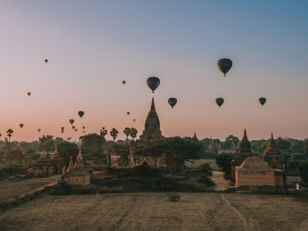 image of hot air balloons flying over temples in bagan, myanmar 