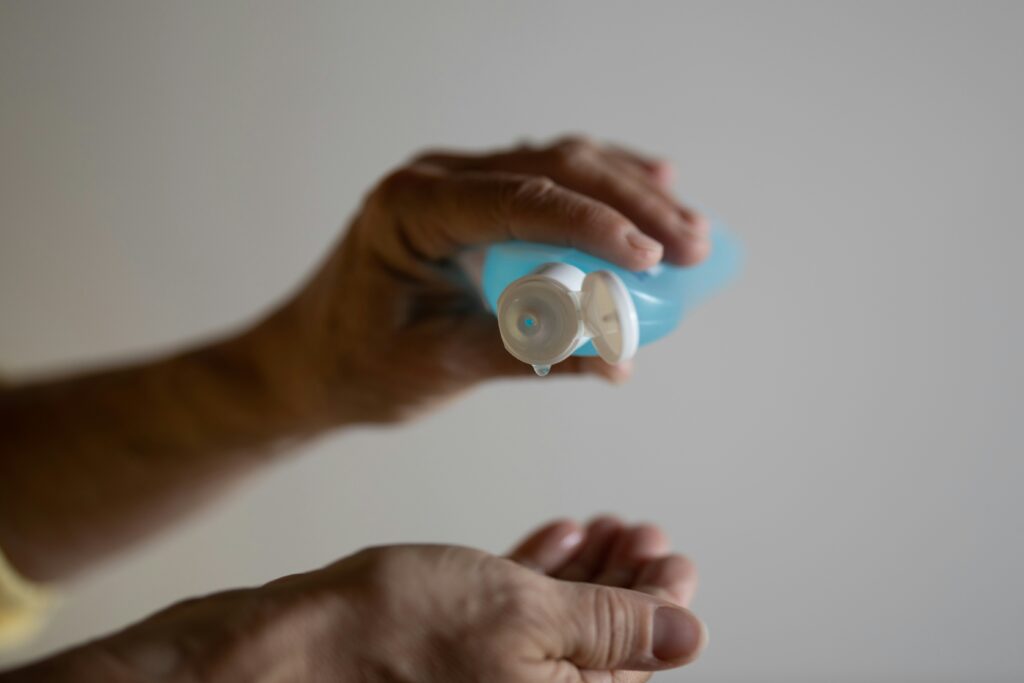 image of man using hand sanitizer 