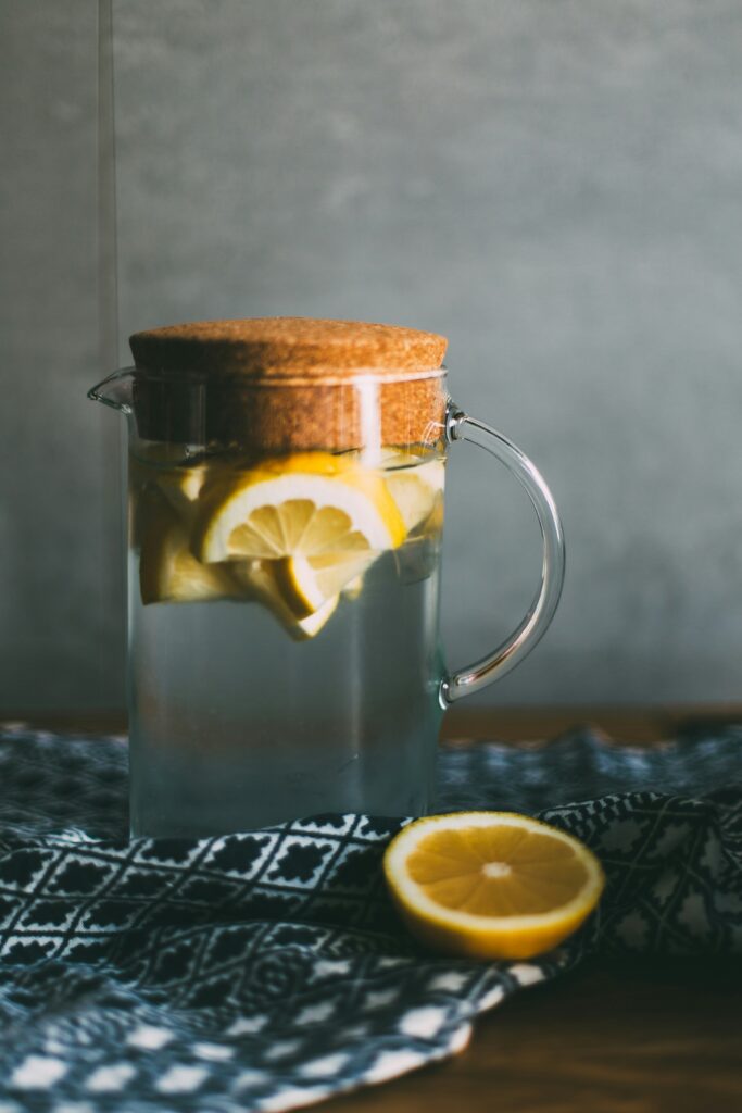 a jug of water infused with lemon slices 