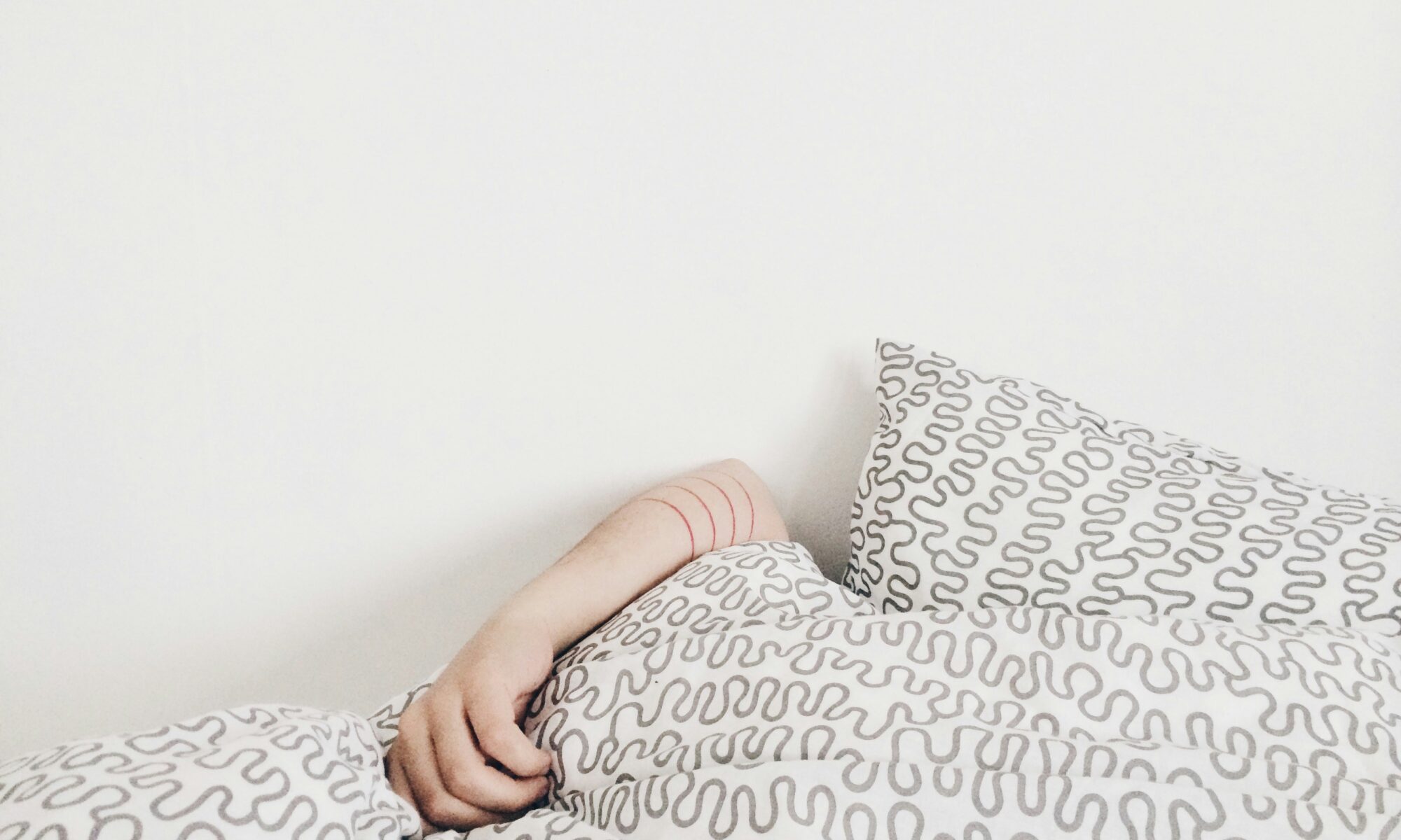 girl sleeping under the covers in an aircon room