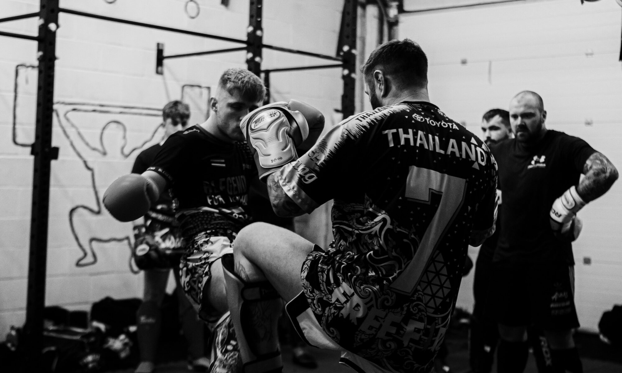 two guys sparring in a kickboxing gym