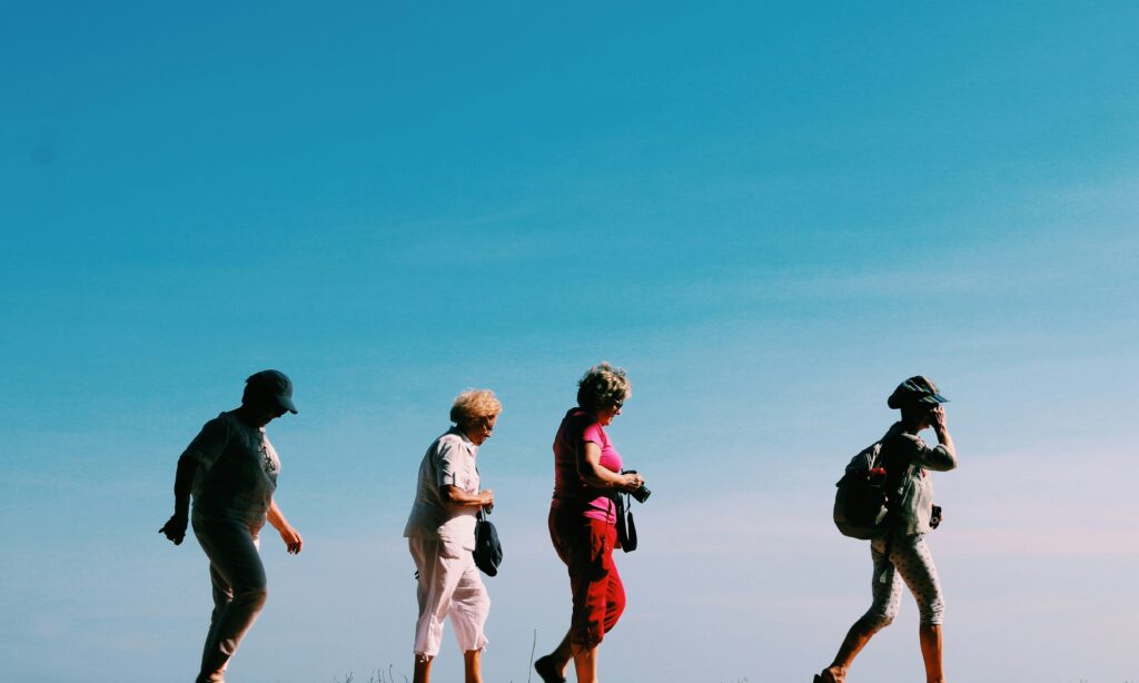 a group of senior citizens socializing on a walk