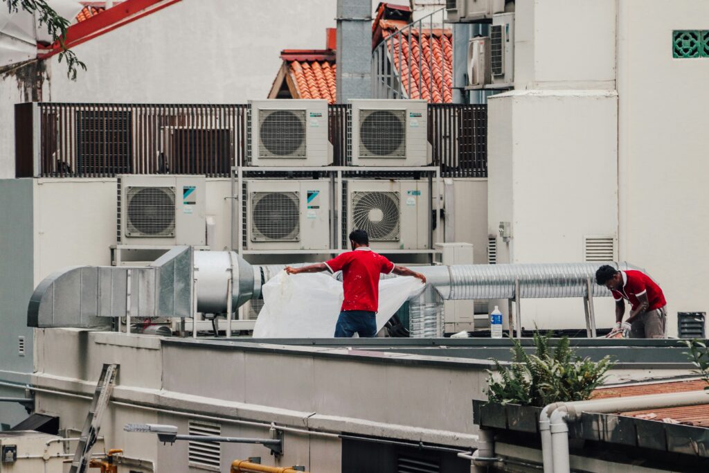 image of technicians fixing aircon