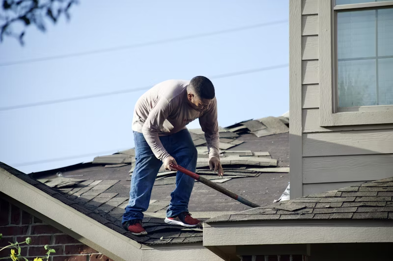 image of a handyman doing minor gutter cleaning