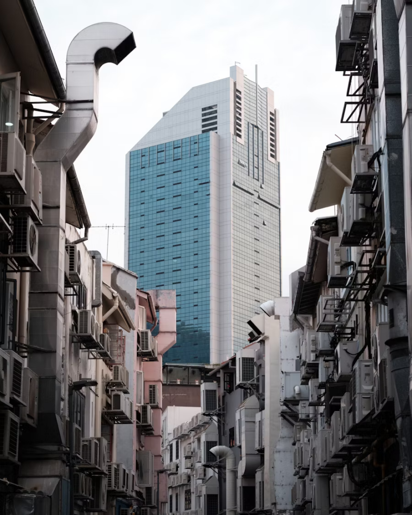 aircon units perched on a stretch of shophouses in an alleyway in Singapore