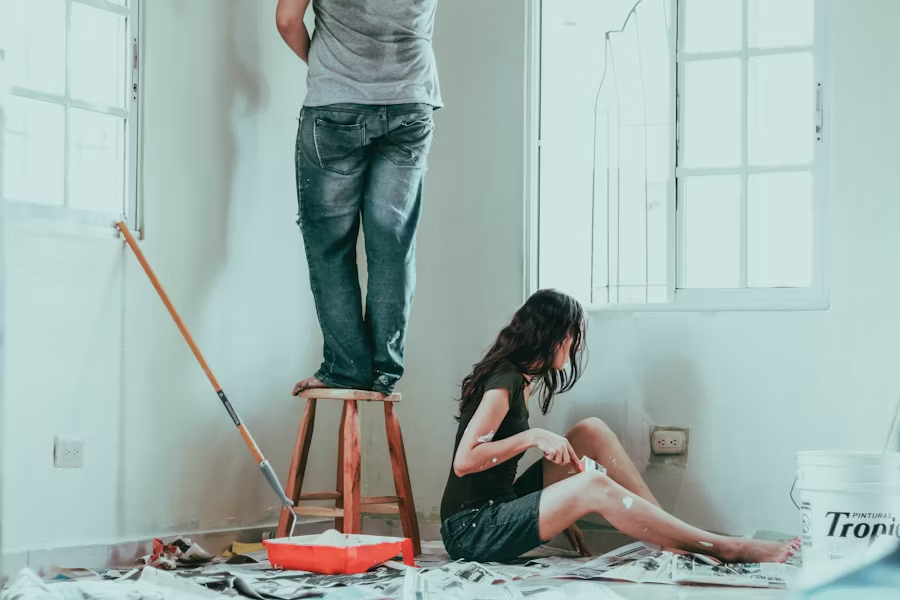 a couple DIY painting their home