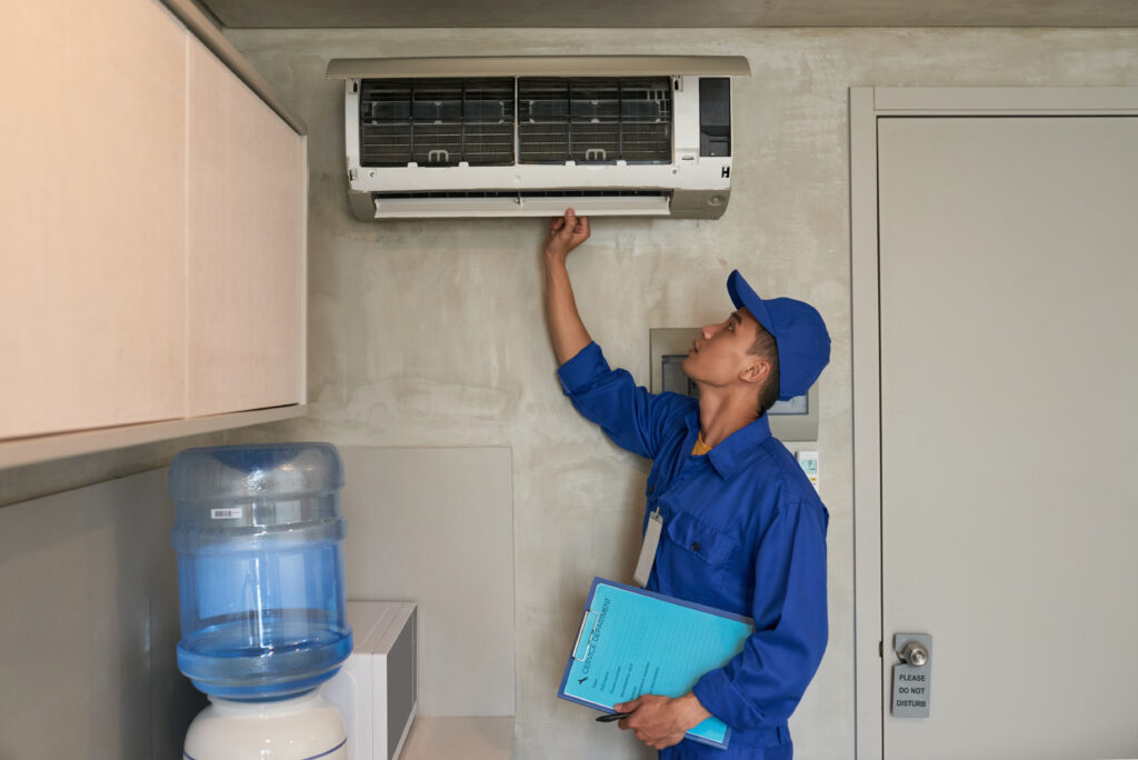 technician inspecting aircon before service