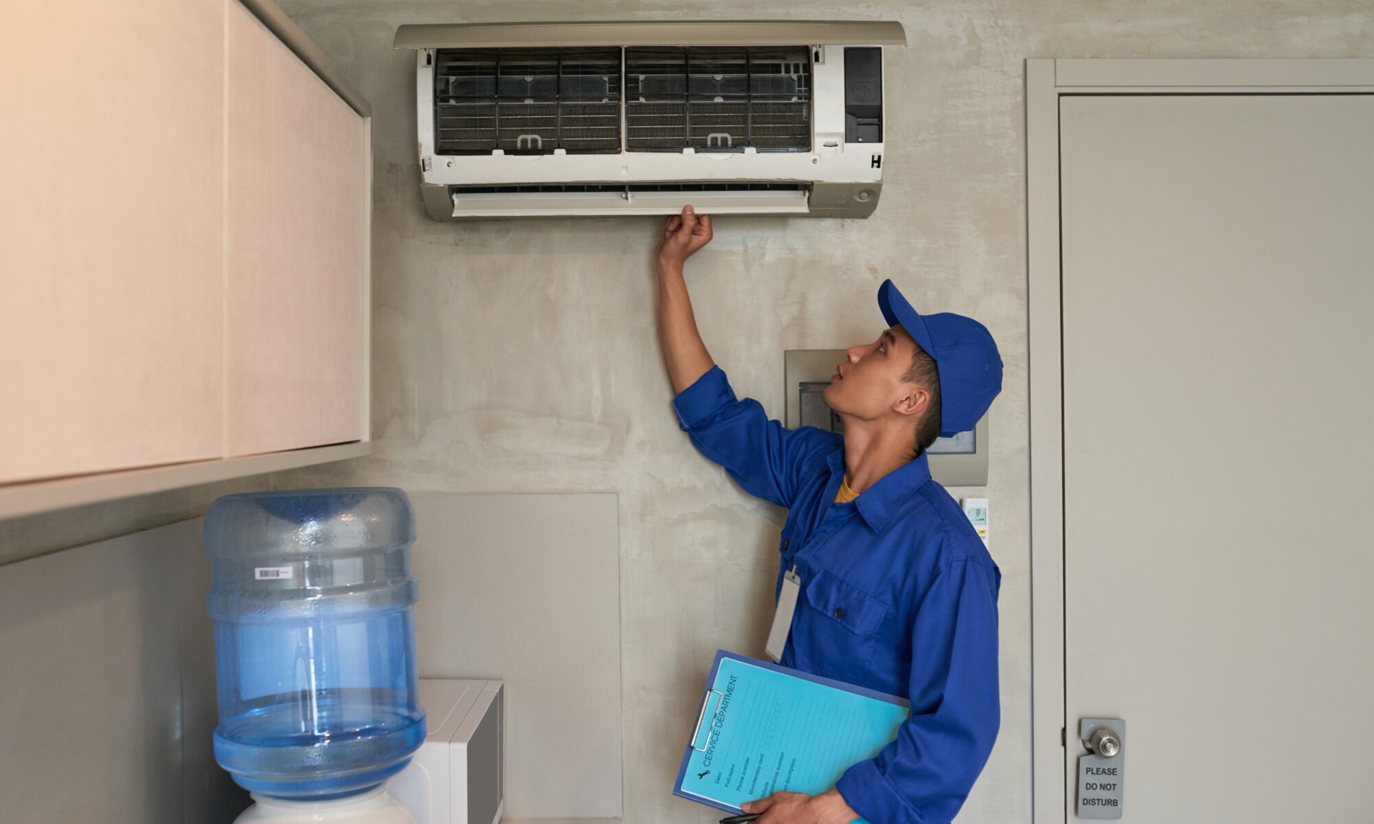 technician inspecting aircon before service